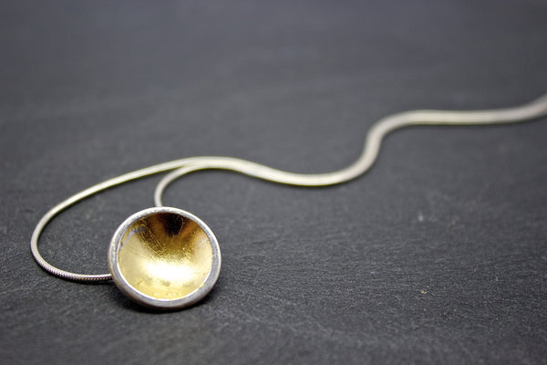 Pendant with small silver and gold leaf dome on silver chain