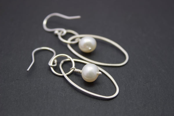 Earrings with oval and freshwater pearl drop