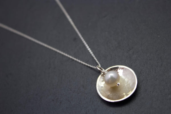 Pendant with domed disc and pearl
