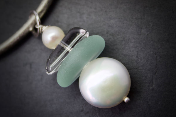 Necklace with curved bar and sea glass drop