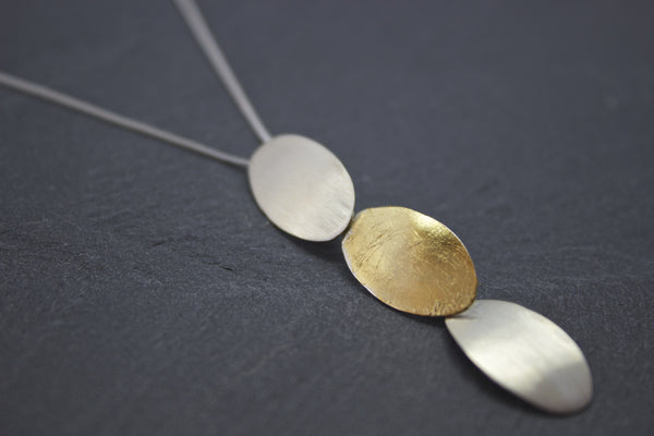 Pendant with silver and gold leaf ovals