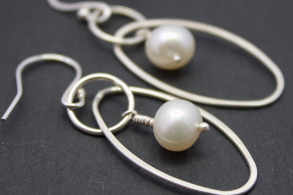 Earrings with oval and freshwater pearl drop