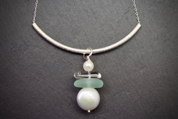 Necklace with curved bar and sea glass drop